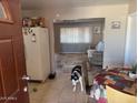 Open entryway with tile floors, an adjacent living room with a couch and a view of the kitchen at 17862 N 31St Ave, Phoenix, AZ 85053