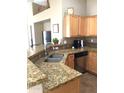 Granite countertops and modern wood cabinets in kitchen at 2030 N 108Th N Dr, Avondale, AZ 85392