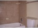 Bathroom with a shower/tub combo and tile surround at 2138 W Beaubien Dr, Phoenix, AZ 85027