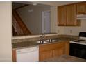 Kitchen with double sink, dishwasher, and wood cabinets at 2138 W Beaubien Dr, Phoenix, AZ 85027