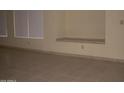 Living room with tile flooring and built-in shelving at 2138 W Beaubien Dr, Phoenix, AZ 85027