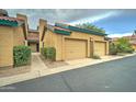 Tan stucco building with a double garage and walkway at 225 W 1St St # 118, Mesa, AZ 85201