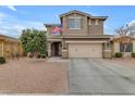 Two-story house with beige exterior, two-car garage, and American flag at 2346 S Banning St, Gilbert, AZ 85295