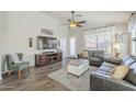 Cozy living room featuring wood-look floors and a fireplace at 2414 W Gambit Trl, Phoenix, AZ 85085