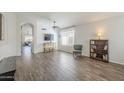 Open living room with wood-look floors and built-in shelving at 2414 W Gambit Trl, Phoenix, AZ 85085