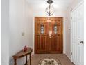 Entryway with wood double doors and tile flooring at 26602 S Nicklaus Dr, Sun Lakes, AZ 85248