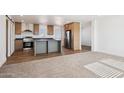 Open kitchen and carpeted living room offer modern living space at 2707 S 357Th Dr, Tonopah, AZ 85354