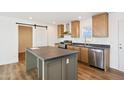 Kitchen with stainless steel appliances, ample cabinet space, and center island at 2707 S 357Th Dr, Tonopah, AZ 85354