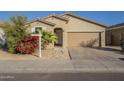 Tan colored single story house with attached garage and red flowering bush at 2838 W Apollo Rd, Phoenix, AZ 85041