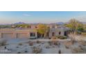 Aerial view of stucco home with desert landscaping and mountain backdrop at 30600 N Pima Rd # 33, Scottsdale, AZ 85266