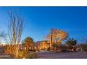 Night view of stucco home with desert landscaping at 30600 N Pima Rd # 33, Scottsdale, AZ 85266