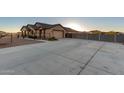 Long concrete driveway leading to a two-car garage at 30964 N Grace Ln, Queen Creek, AZ 85144