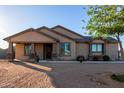 Tan house with a covered porch and stone accents at 30964 N Grace Ln, Queen Creek, AZ 85144