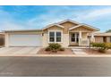 Tan house with white trim, attached garage, and small porch at 3301 S Goldfield Rd # 4065, Apache Junction, AZ 85119