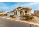 Tan house with white trim, attached garage, and small porch at 3301 S Goldfield Rd # 4065, Apache Junction, AZ 85119