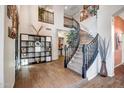 Two-story entryway showcasing a curved staircase and tile flooring at 339 E Horseshoe Ave, Gilbert, AZ 85296