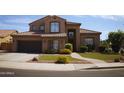 Charming two-story home with well-manicured lawn, tiled roof and inviting walkway at 339 E Horseshoe Ave, Gilbert, AZ 85296