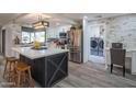 Modern kitchen with white cabinets and a large island at 3402 E Sunnyside Dr, Phoenix, AZ 85028