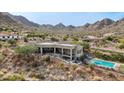 Aerial view of house, showcasing the backyard, pool, and mountain views at 34157 N Mirage Ct, San Tan Valley, AZ 85144