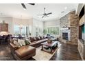 Spacious living room featuring a stone fireplace and hardwood floors at 34157 N Mirage Ct, San Tan Valley, AZ 85144