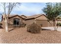 House exterior with a two-car garage and desert landscaping at 3718 E Elmington Cir, San Tan Valley, AZ 85140