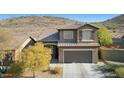 Two-story home with attached garage and desert landscaping at 38213 N Raleigh Way, Anthem, AZ 85086