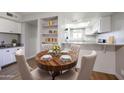 Dining area with a round wooden table and four chairs at 4050 E Cactus Rd # 201, Phoenix, AZ 85032