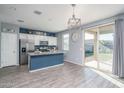 Modern kitchen with blue cabinets, granite counters, and island at 416 N 110Th Ave, Avondale, AZ 85323