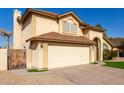 Two-story house with beige exterior, two-car garage, and a wooden gate at 4250 E Towne Ln, Gilbert, AZ 85234