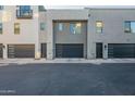 Modern townhome garage featuring black doors and neutral stucco at 4354 N 27Th Pl, Phoenix, AZ 85016