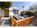 Bright front porch with yellow door and wooden fence at 45 E Woodward Dr, Phoenix, AZ 85004