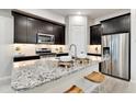 Modern kitchen with granite countertops and breakfast bar at 4931 E Village Dr, Scottsdale, AZ 85254