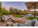 Outdoor oasis with fire pit, spa, and mountain backdrop at 4949 E Lincoln Dr # 34, Paradise Valley, AZ 85253