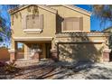 Two-story house with a tan exterior, attached garage, and landscaping at 5496 S 237Th Ln, Buckeye, AZ 85326