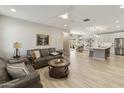 Open living room and kitchen area with leather sofas and wood flooring at 5715 S Winchester --, Mesa, AZ 85212