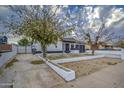 House exterior showcasing the front yard, driveway, and surrounding neighborhood at 6145 W Pierce St, Phoenix, AZ 85043