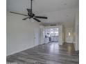 Bright living room with gray vinyl flooring and a view into the kitchen at 6145 W Pierce St, Phoenix, AZ 85043