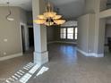 Spacious dining room with tile floors and a large chandelier at 7146 W Emile Zola Ave, Peoria, AZ 85381