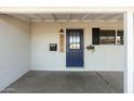 Inviting front door entrance with blue door and a covered porch at 7301 E Almeria Rd, Scottsdale, AZ 85257