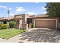 Front view of a tan house with a tile roof, and a two car garage at 7729 N Via De Fonda --, Scottsdale, AZ 85258