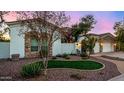 Curb appeal abounds in this beautiful home with a three-car garage and lush landscaping at 8951 E Wethersfield Rd, Scottsdale, AZ 85260