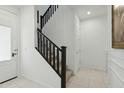 Modern staircase with dark wood railing and white walls at 9835 E Stratus Ave, Mesa, AZ 85212