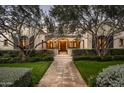 Stunning home with arched entryway, lush landscaping, and stone pathway at 10320 E Mountain Spring Rd, Scottsdale, AZ 85255