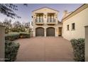 Two-car garage with carriage-style doors and second story balcony at 10320 E Mountain Spring Rd, Scottsdale, AZ 85255