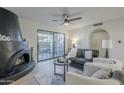 Living room with fireplace, sliding glass door and modern furniture at 10410 N Cave Creek Rd # 1220, Phoenix, AZ 85020