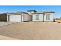 Newly built house with a two-car garage, light-colored exterior, and gravel driveway at 12360 W Delwood Dr, Arizona City, AZ 85123