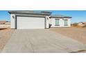 Modern house with a two-car garage and a large concrete driveway at 12360 W Delwood Dr, Arizona City, AZ 85123