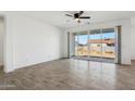 Bright living room with wood-look floors and sliding glass doors to backyard at 12360 W Delwood Dr, Arizona City, AZ 85123