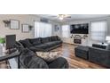 Living room with sectional sofa, large TV and fireplace at 12409 W Montebello Ave, Litchfield Park, AZ 85340