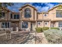 Front view of a two-story townhome with a paved walkway and landscaping at 13842 S 40Th St # 1004, Phoenix, AZ 85044